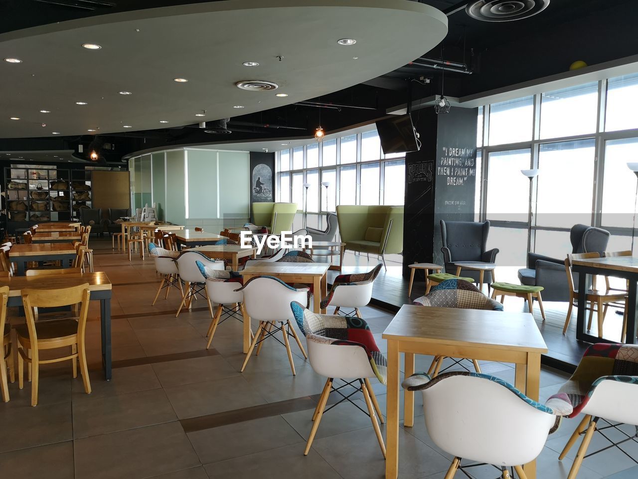 EMPTY CHAIRS AND TABLES IN CAFE