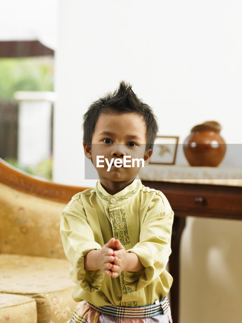 Portrait of cute boy standing at home