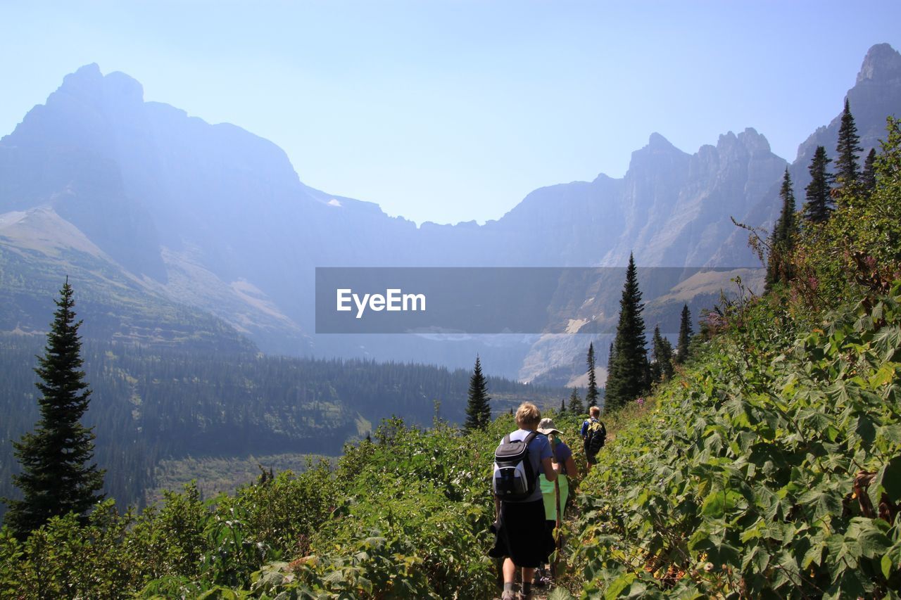 WOMAN STANDING ON MOUNTAIN