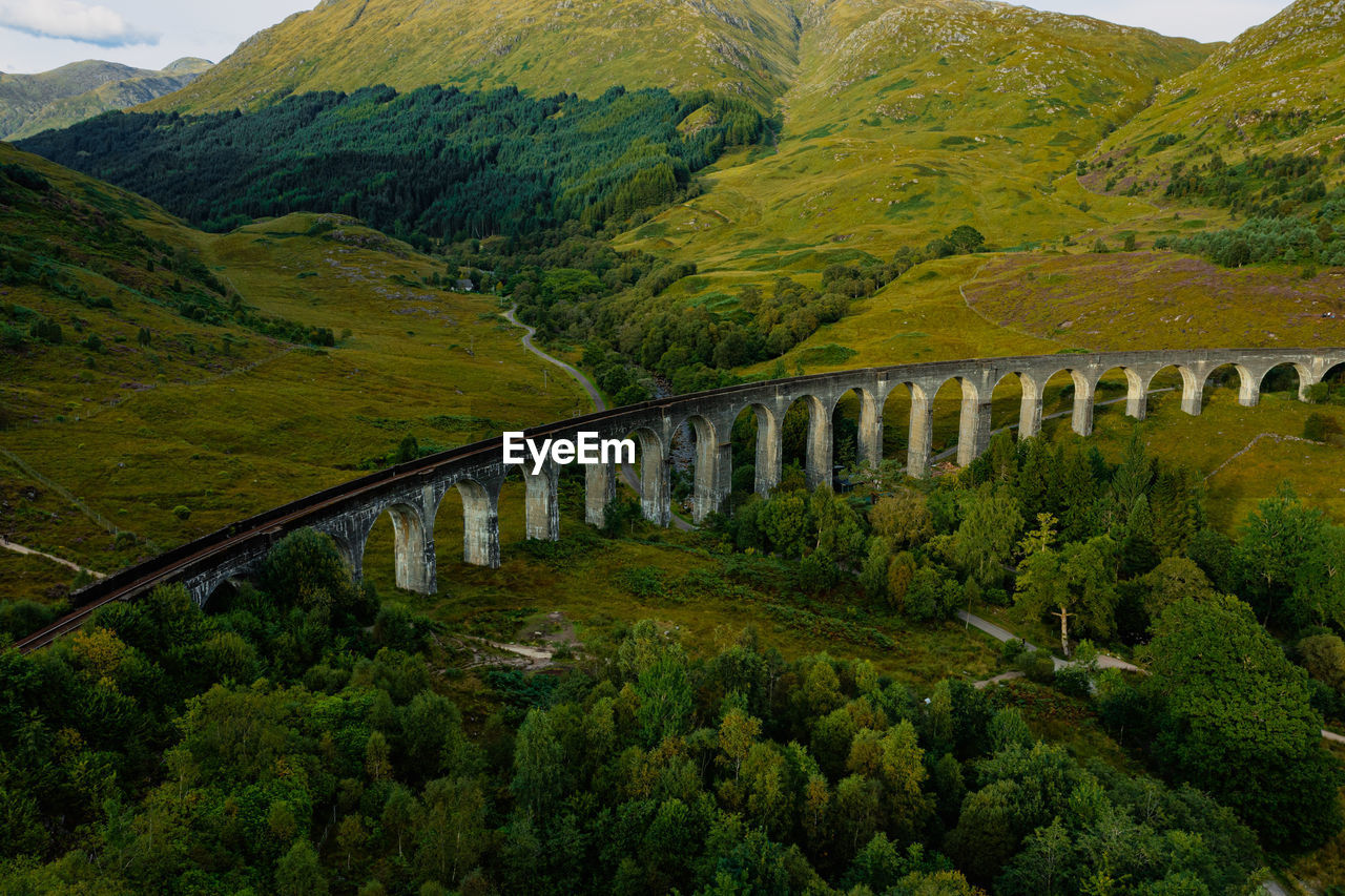 Glenfinnan historic rail viaduct in scottish highlands. full frame wide angle view in clouds day