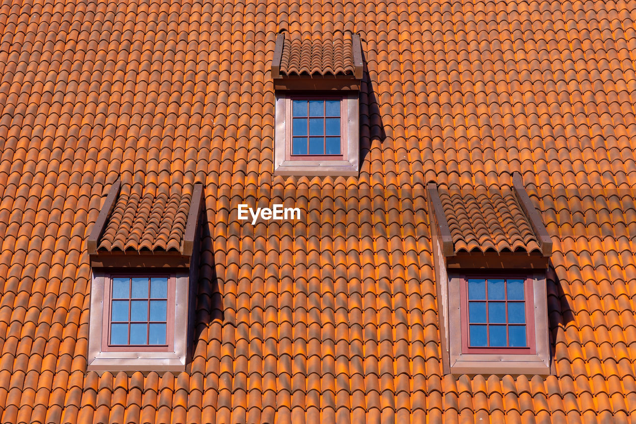 architecture, building exterior, built structure, window, brick, building, roof, wall, no people, brickwork, facade, house, residential district, roof tile, day, wall - building feature, brick wall, low angle view, wood, outdoors, pattern, orange color, brown, full frame, city, nature, sunlight, blue