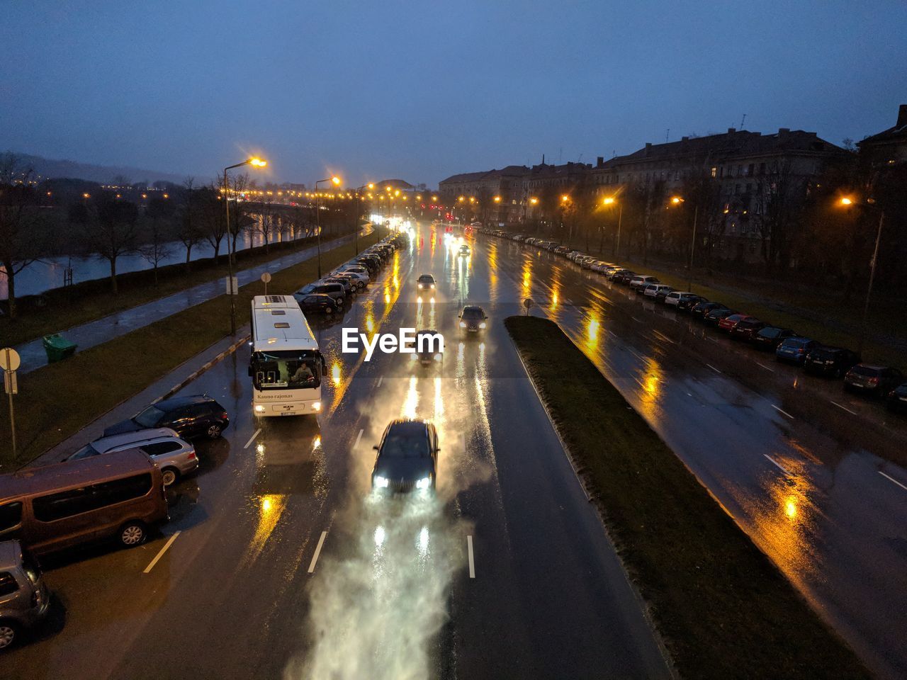 CARS ON ROAD IN CITY AT NIGHT