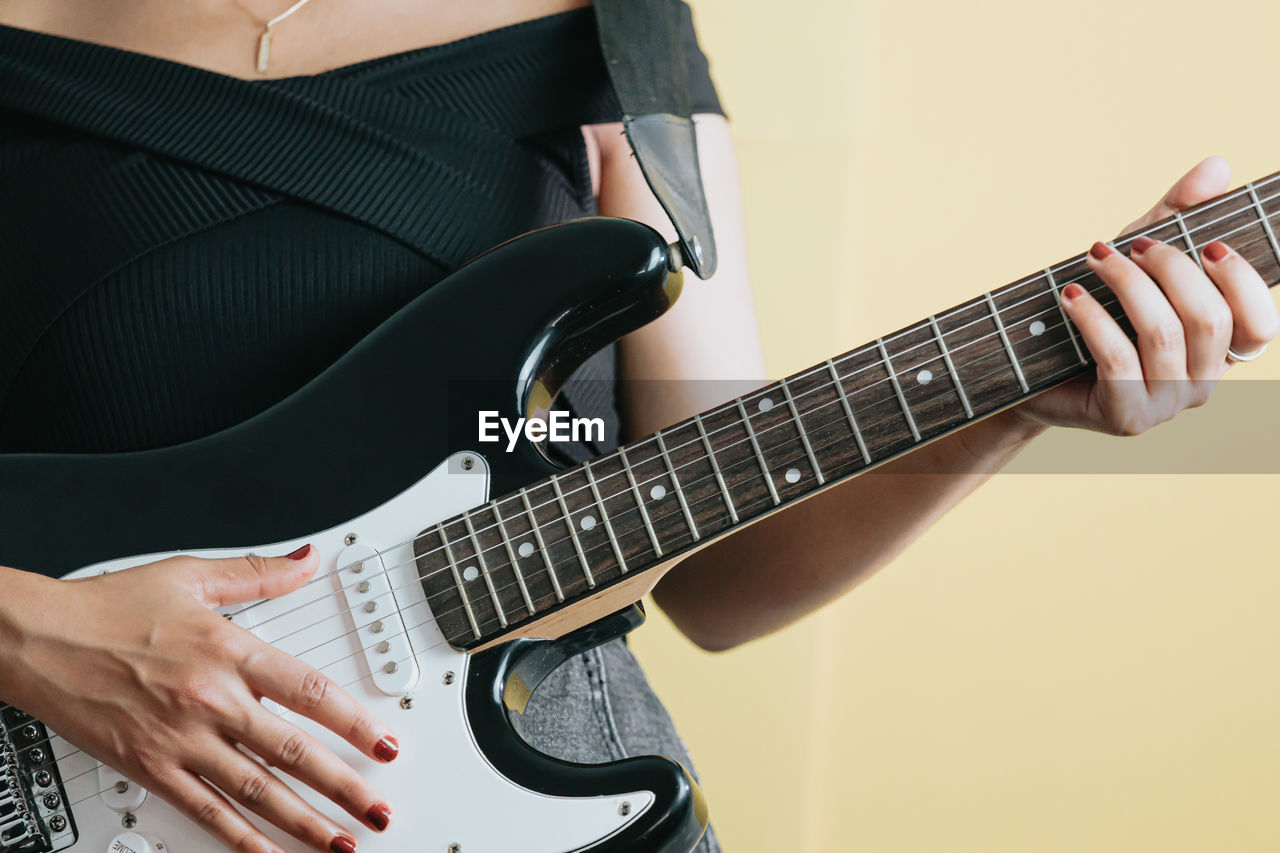 cropped image of man playing guitar