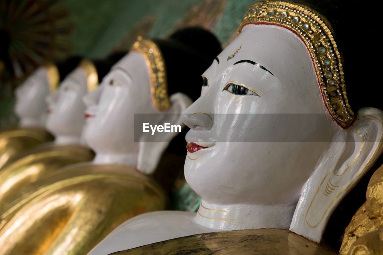 Close-up of buddha statues in temple