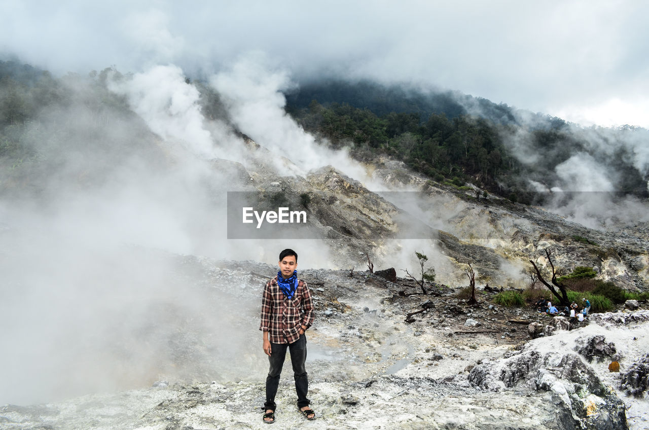 Full length of man standing at kawah ratu in taman nasional gunung halimun salak