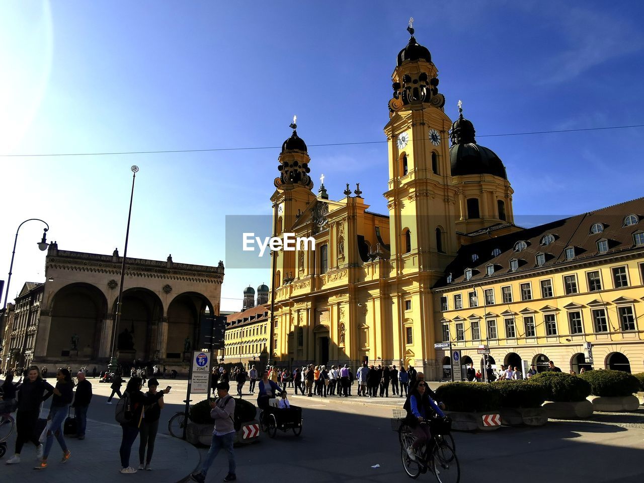 GROUP OF PEOPLE IN FRONT OF BUILDINGS