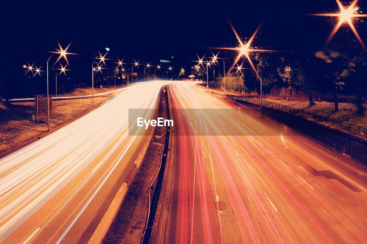 High angle view of light trails on highway at night