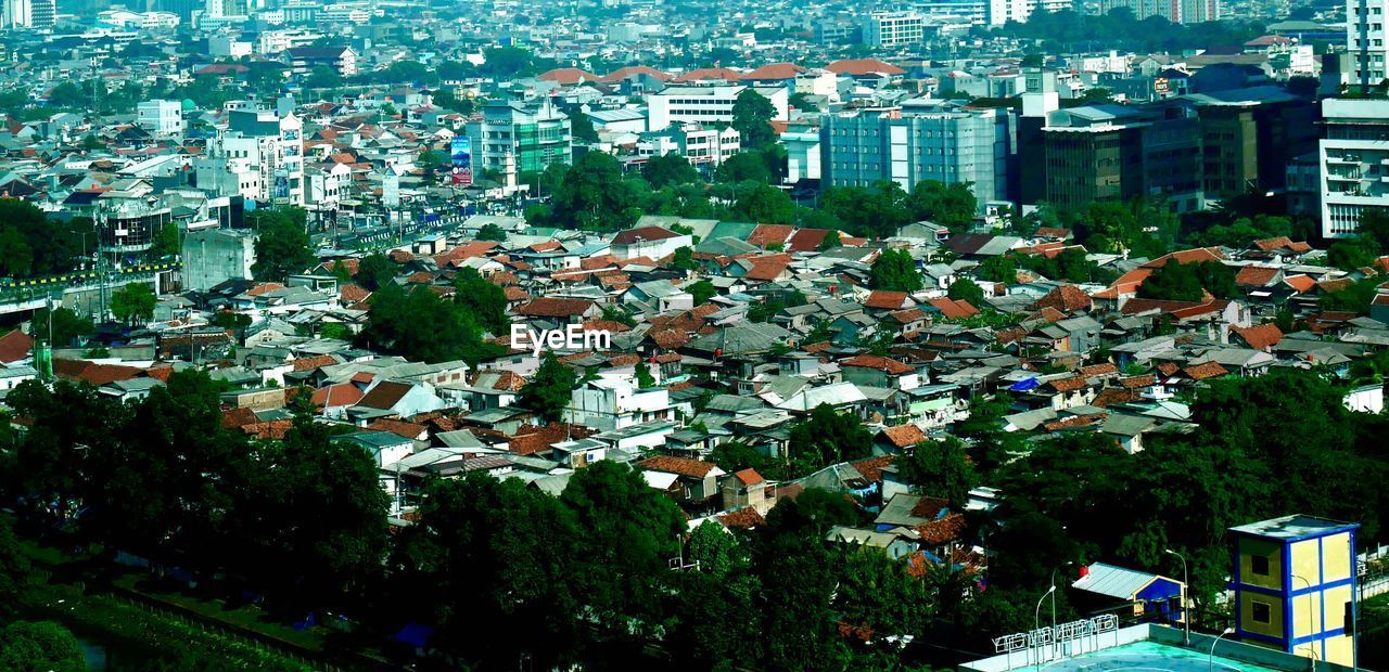 HIGH ANGLE VIEW OF TOWNSCAPE AND TREES BY BUILDINGS