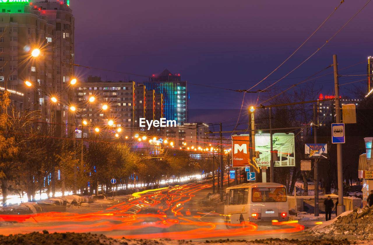 ILLUMINATED CITY AT NIGHT IN WINTER