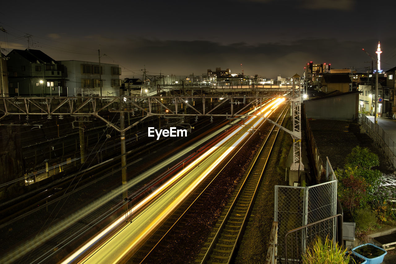 HIGH ANGLE VIEW OF LIGHT TRAILS ON ROAD IN CITY