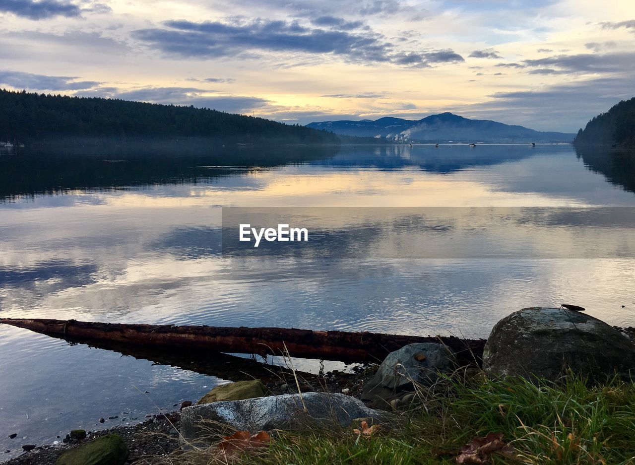 Scenic view of lake against sky during sunset