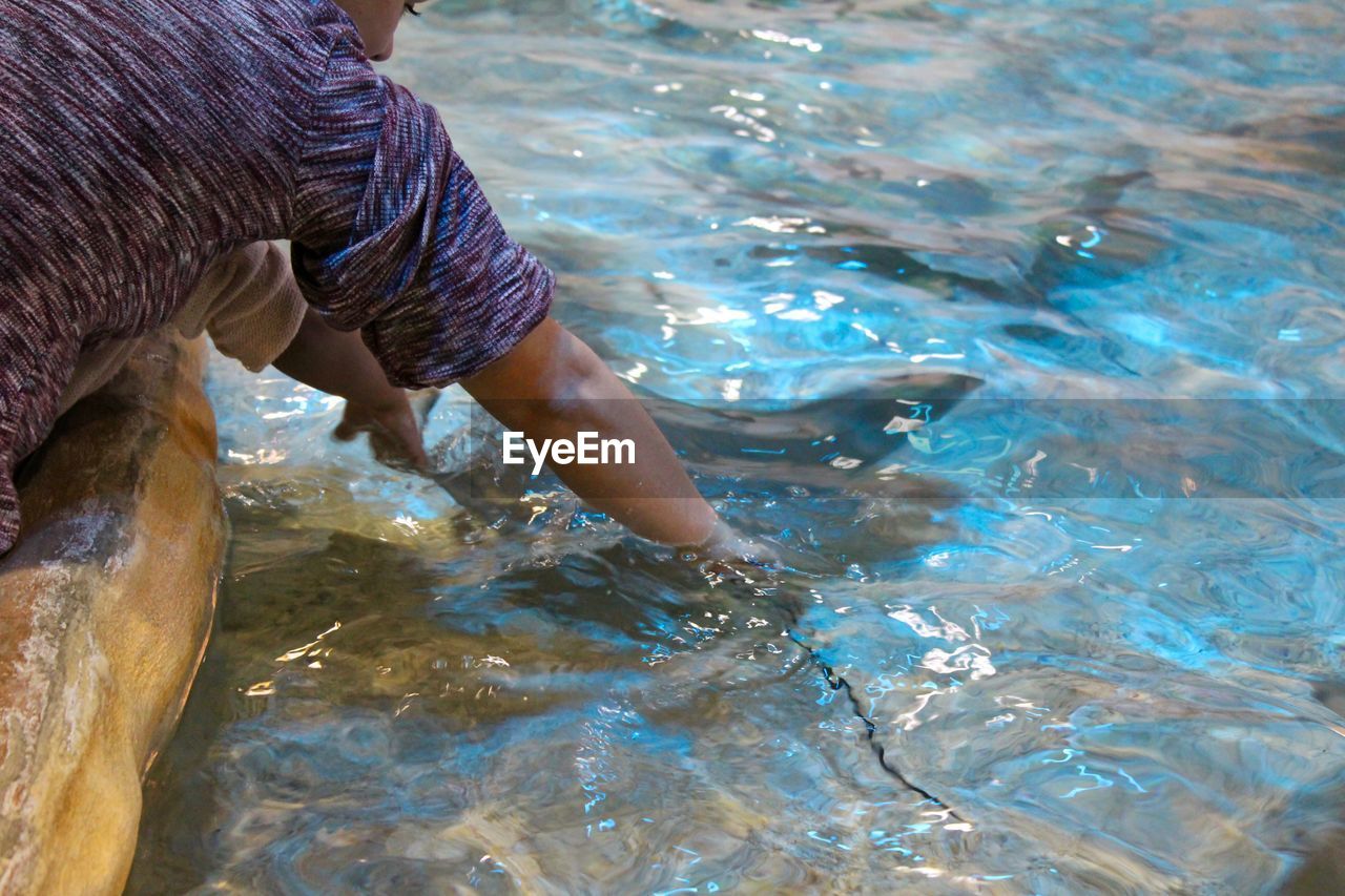 Man catching fish in water