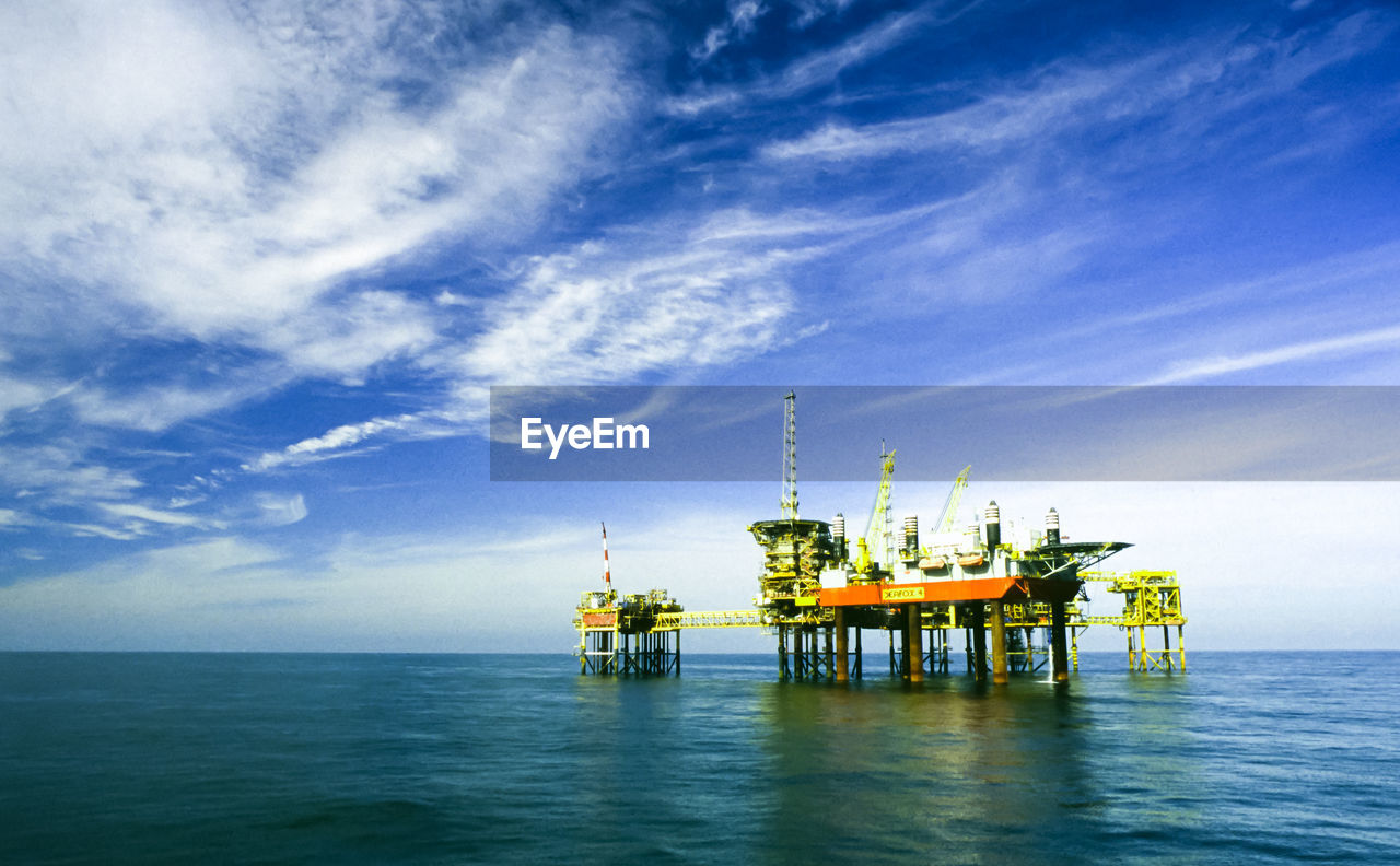 Oil platform complex and maintenance rig in a tranquil sea. 