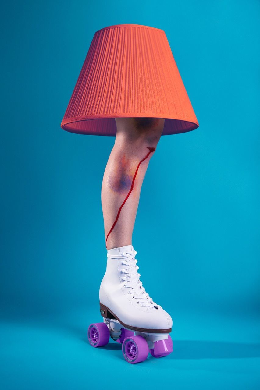 LOW SECTION OF WOMAN WEARING HIGH HEELS AGAINST BLUE BACKGROUND