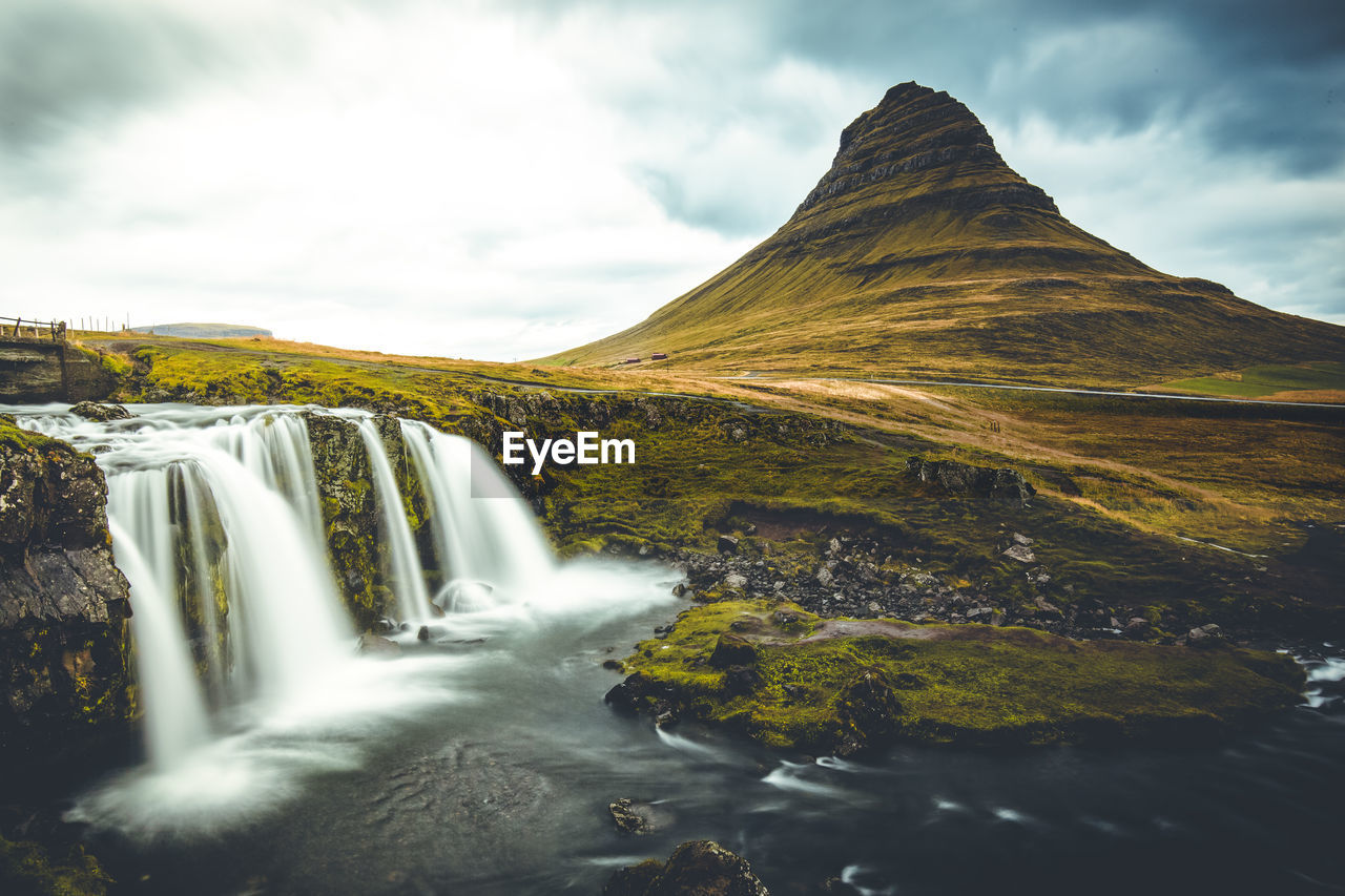 Scenic view of waterfall against sky