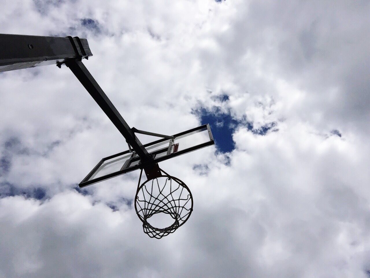 LOW ANGLE VIEW OF BASKETBALL AGAINST SKY