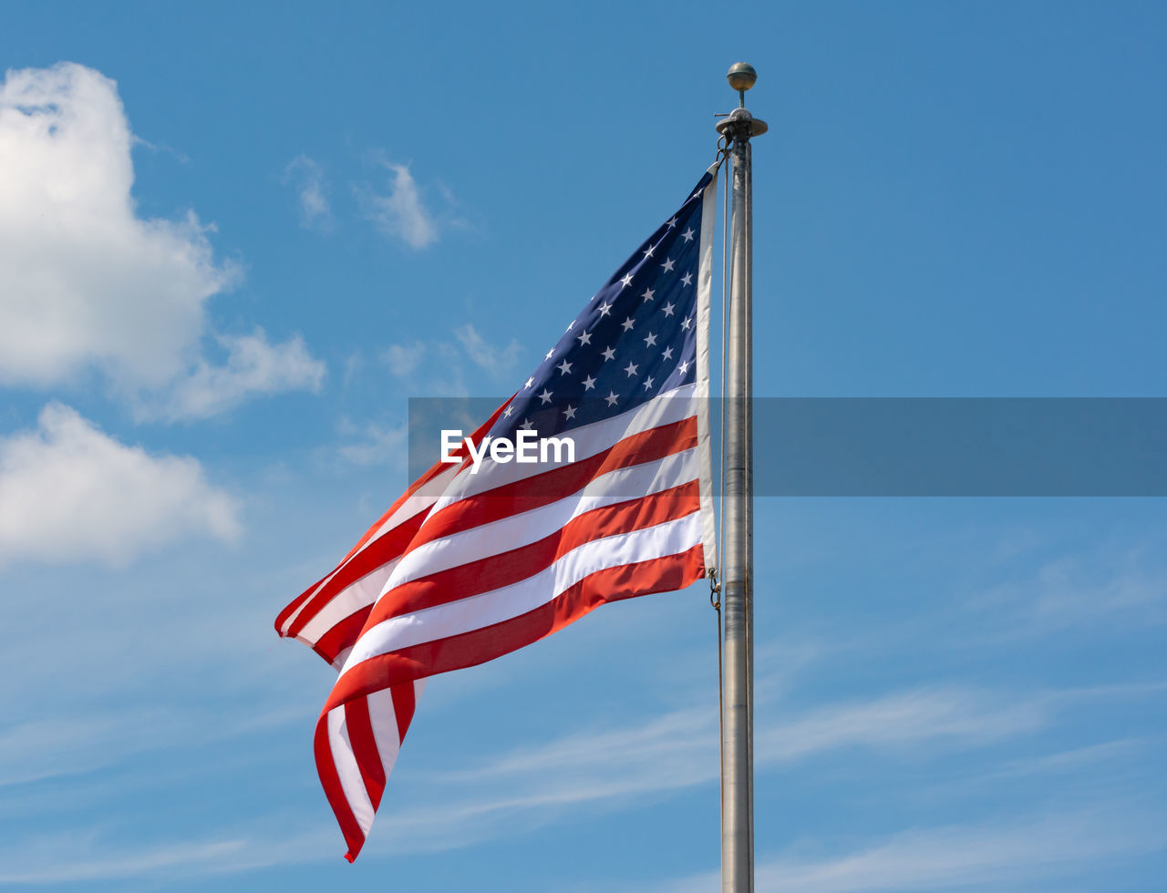 Low angle view of american flag against sky