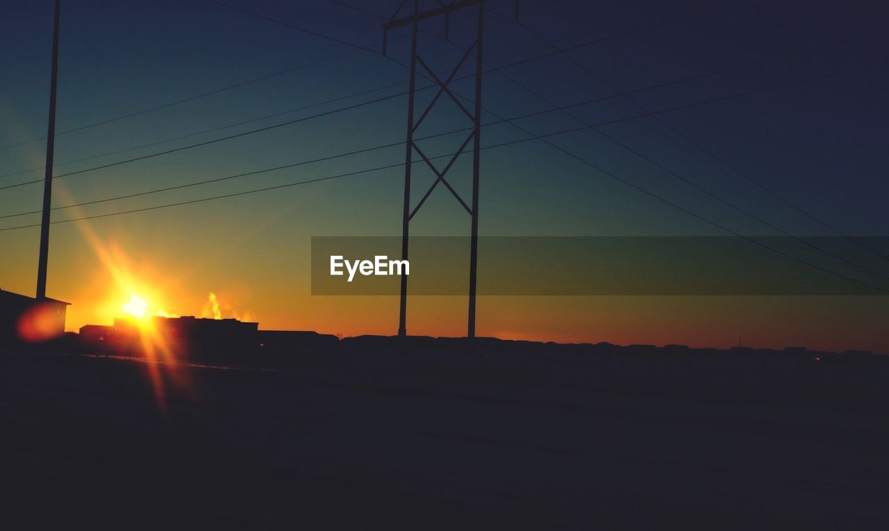 Silhouette of power lines at sunset