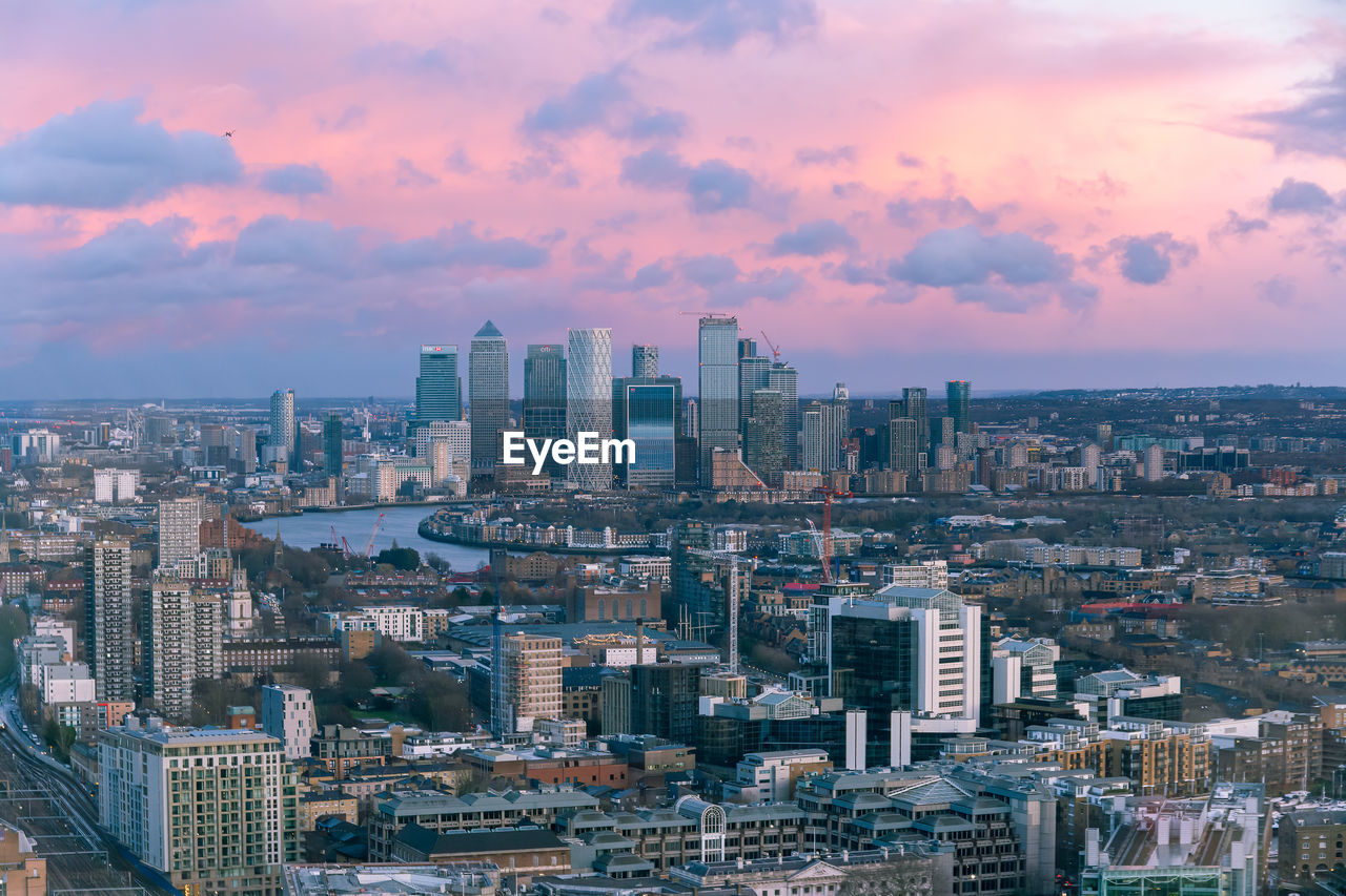Aerial sunset cityscape of london and the river thames with canary wharf in the background