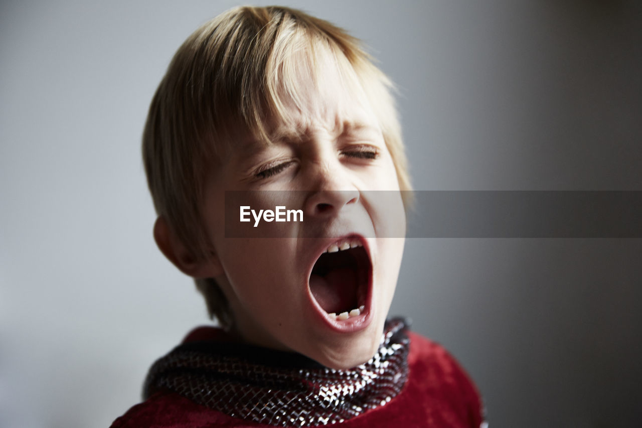 Boy screaming, studio shot