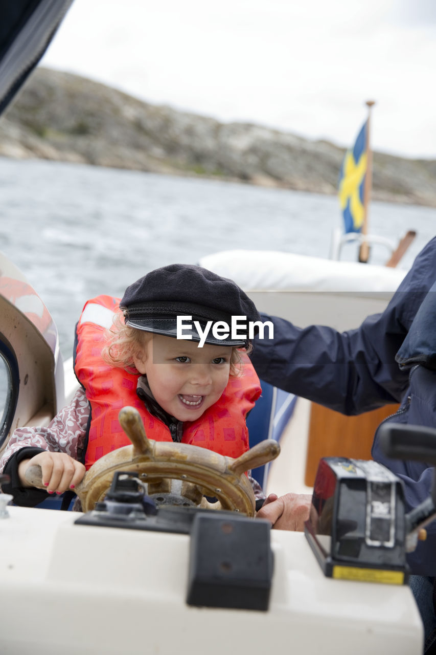 Smiling girl steering boat