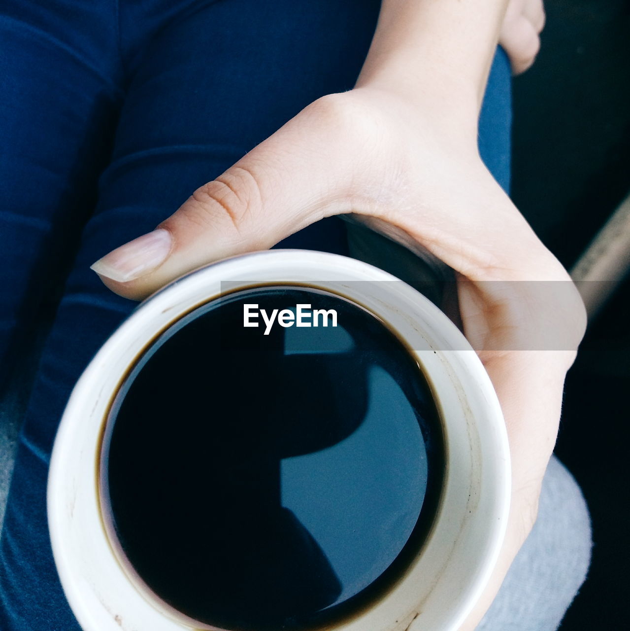 Cropped image of woman holding coffee cup