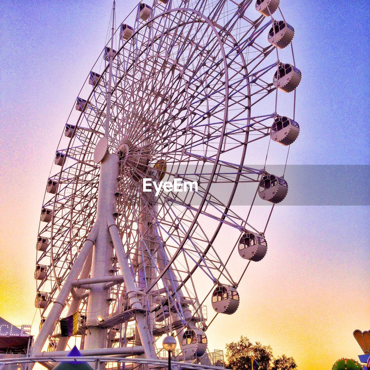 Low angle view of ferris wheel at dusk