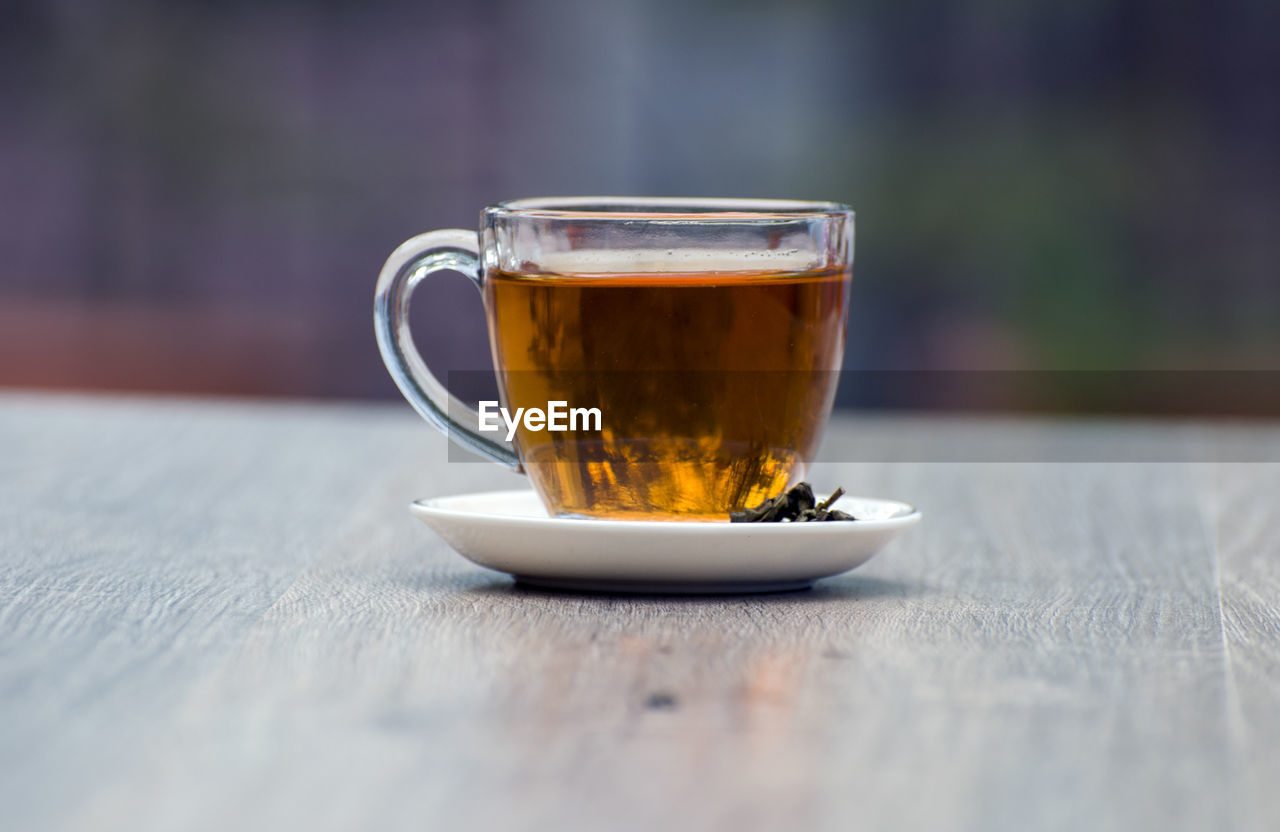 CLOSE-UP OF COFFEE WITH CUP ON TABLE