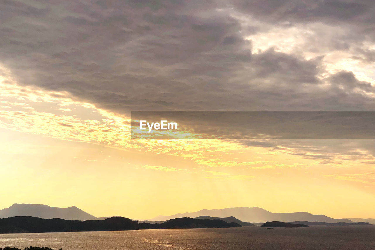 SCENIC VIEW OF SEA AGAINST ORANGE SKY