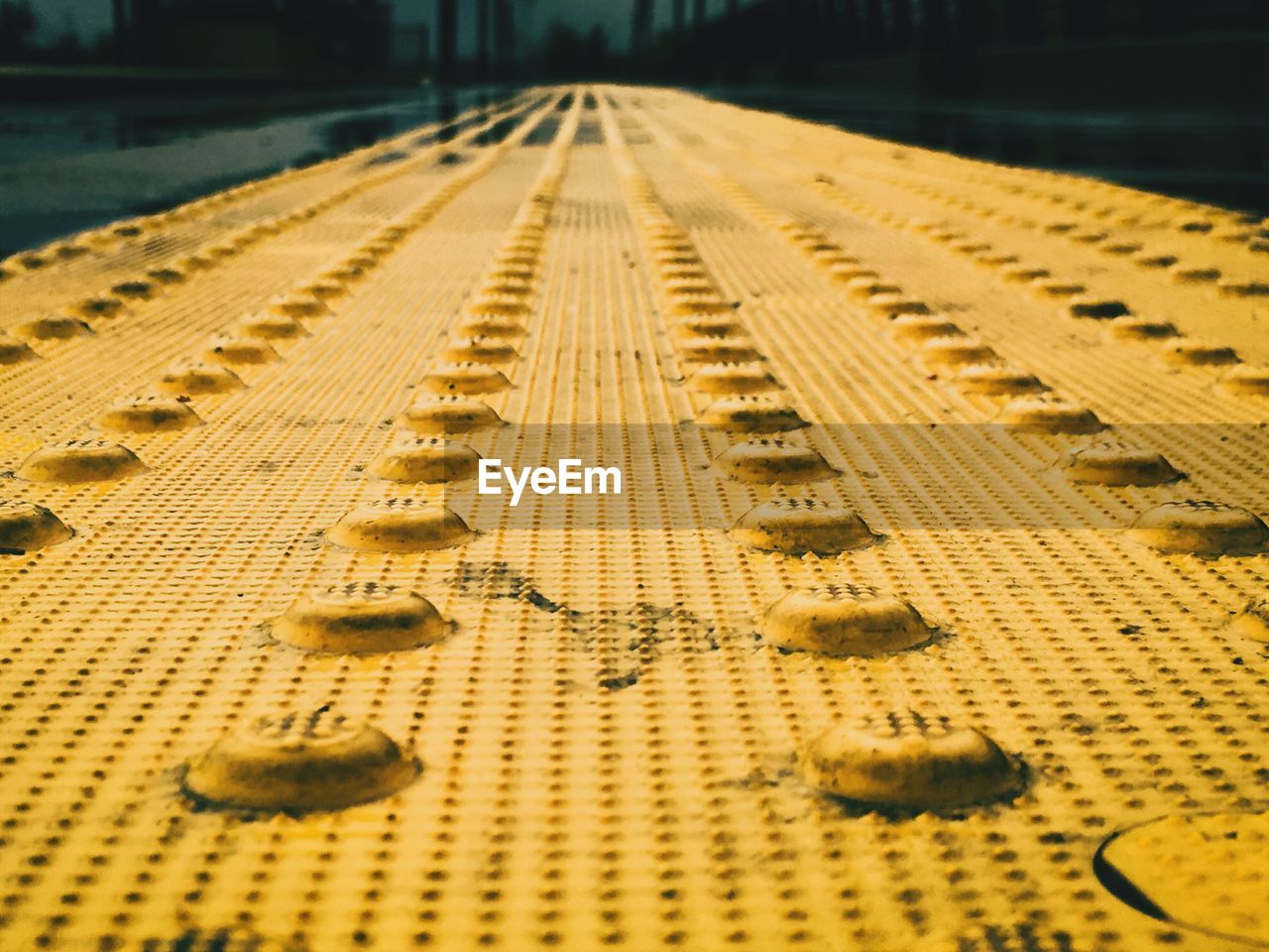 Surface level shot of yellow footpath in city