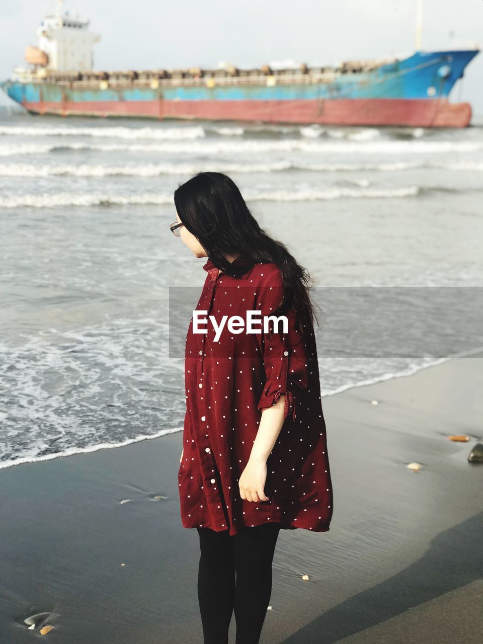 WOMAN LOOKING AT SEA