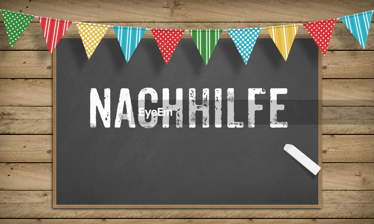 Nachhilfe, german tutoring headline text written on black board with chalk on education illustration