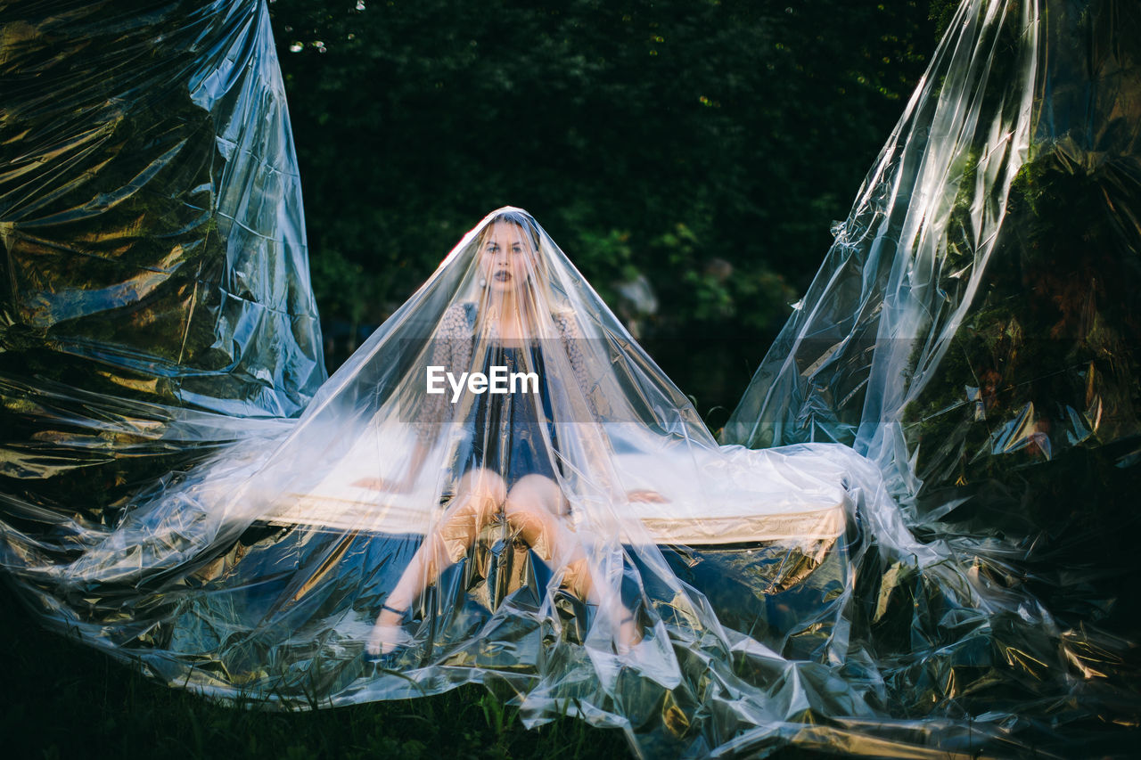 Woman covered in plastic on field