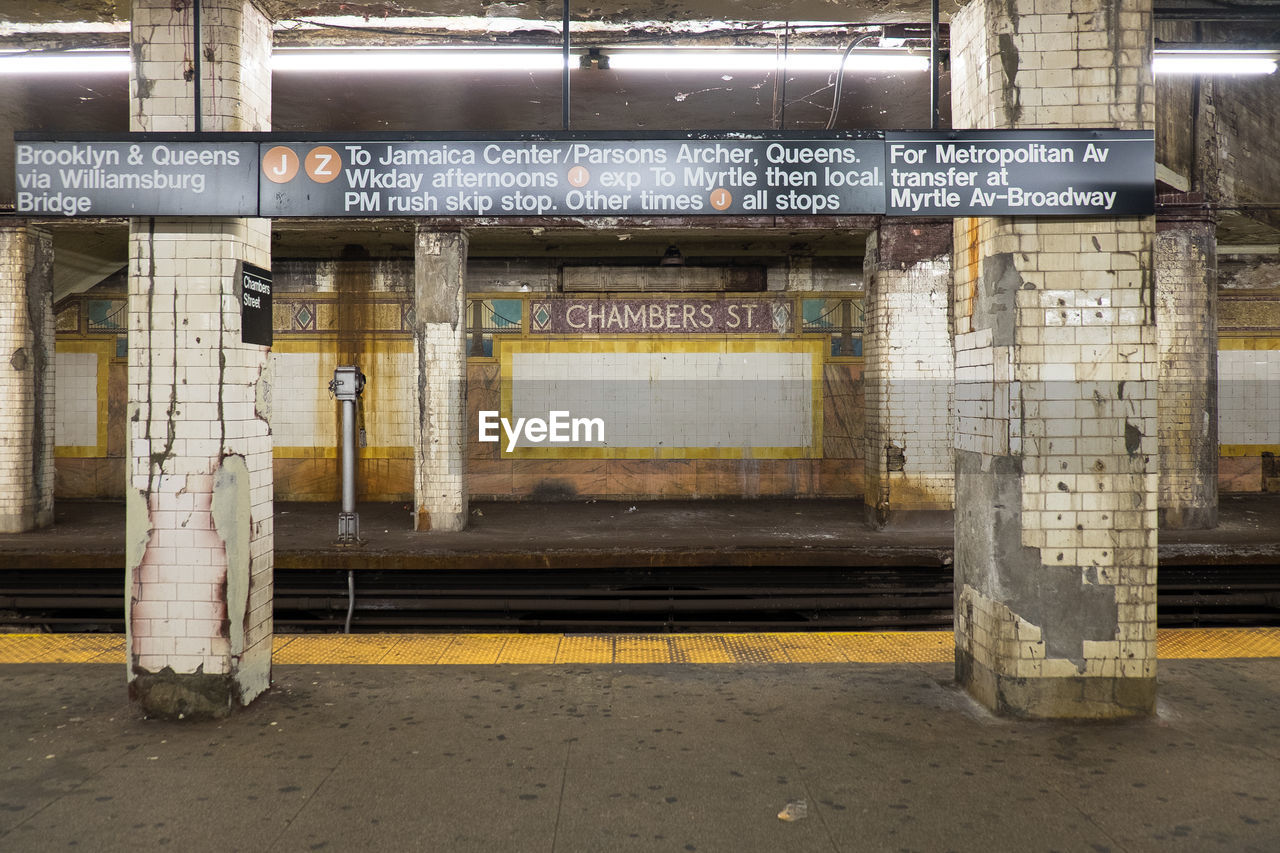 Sign board on columns at railroad station platform