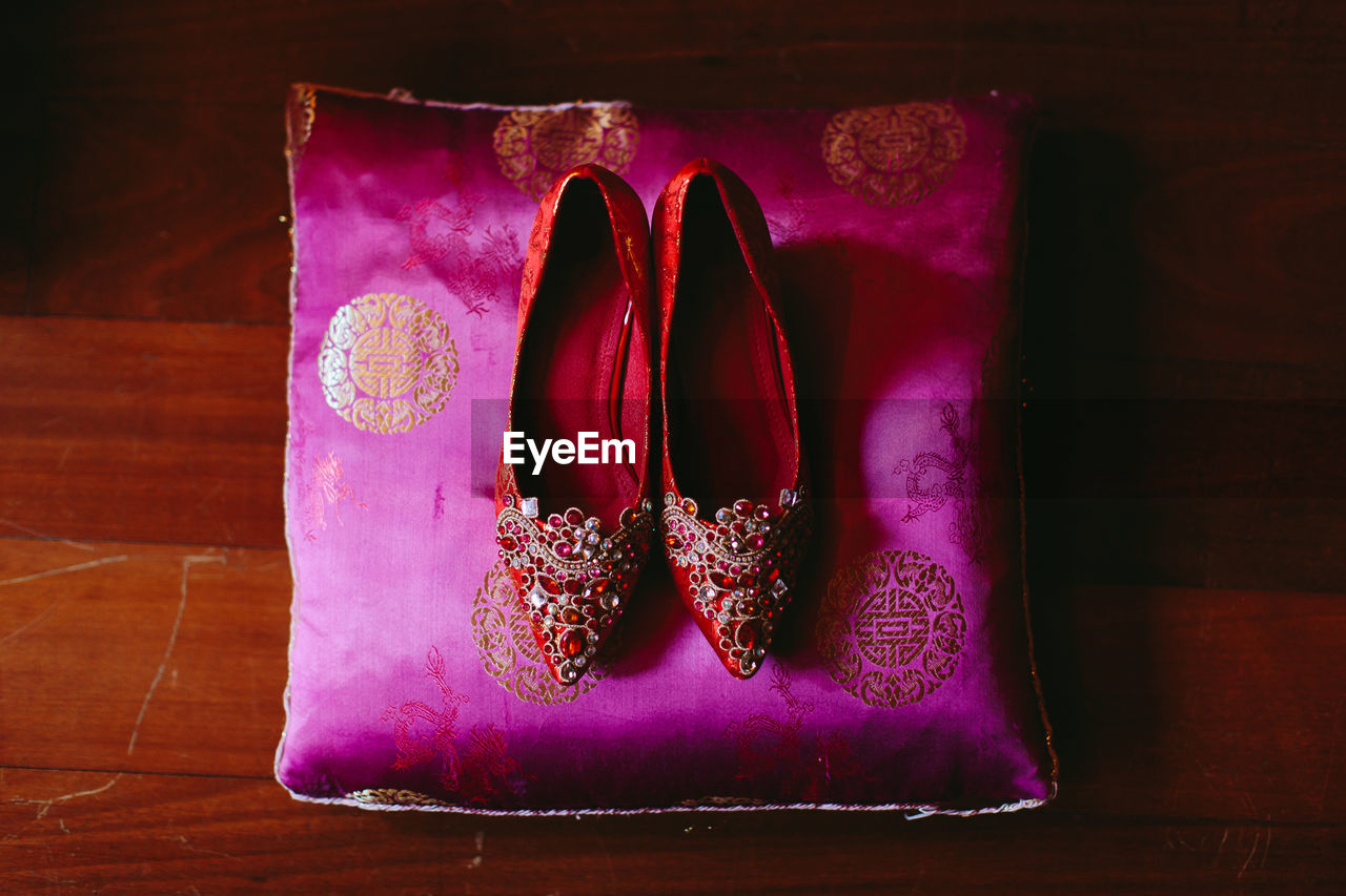 HIGH ANGLE VIEW OF SHOES ON PINK TABLE