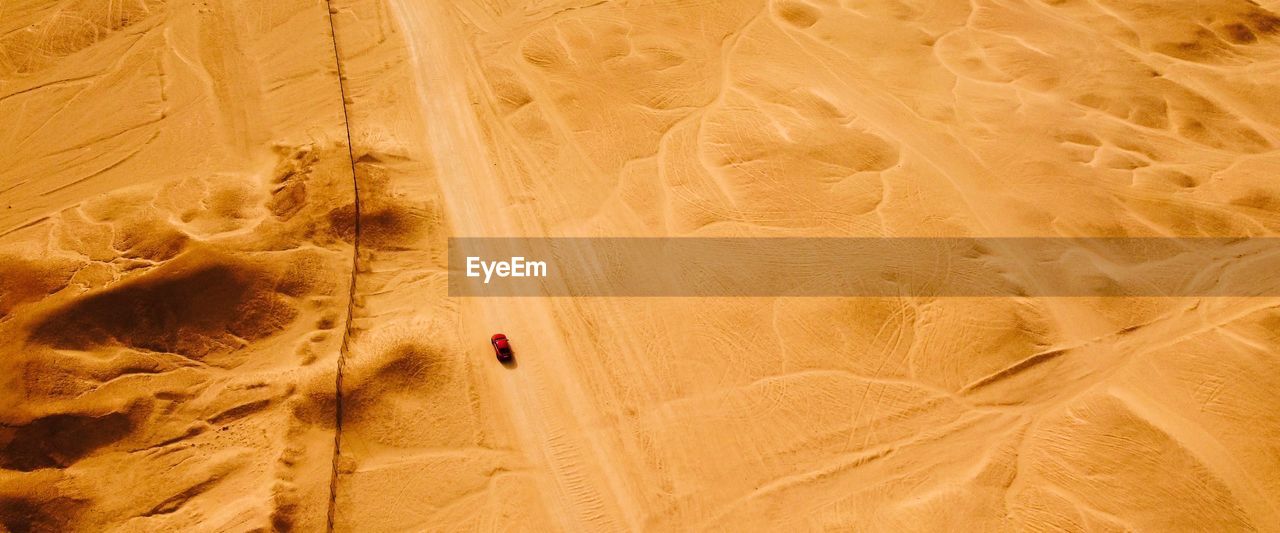 Drone view of car passing through desert