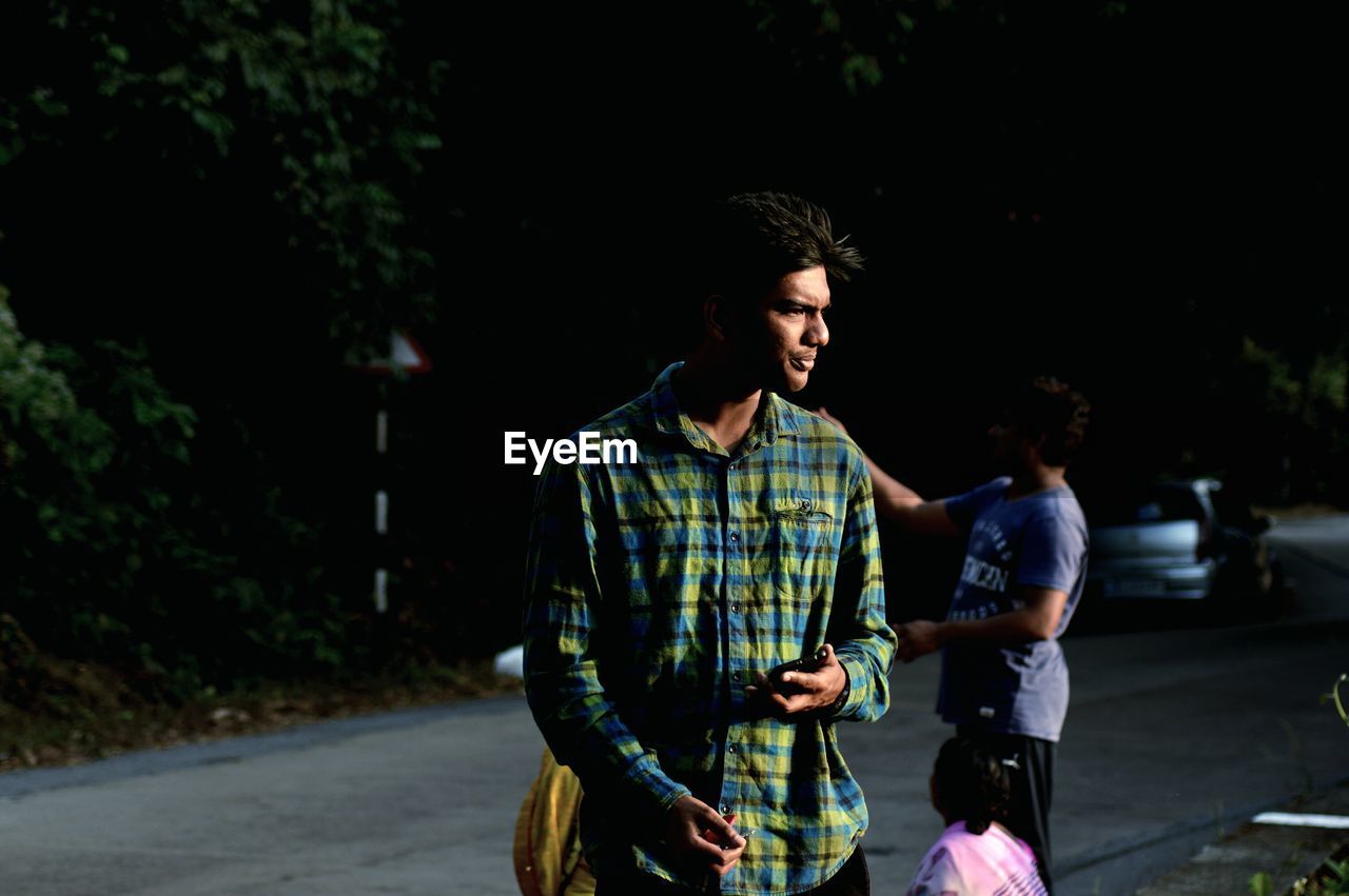 Young man standing on street