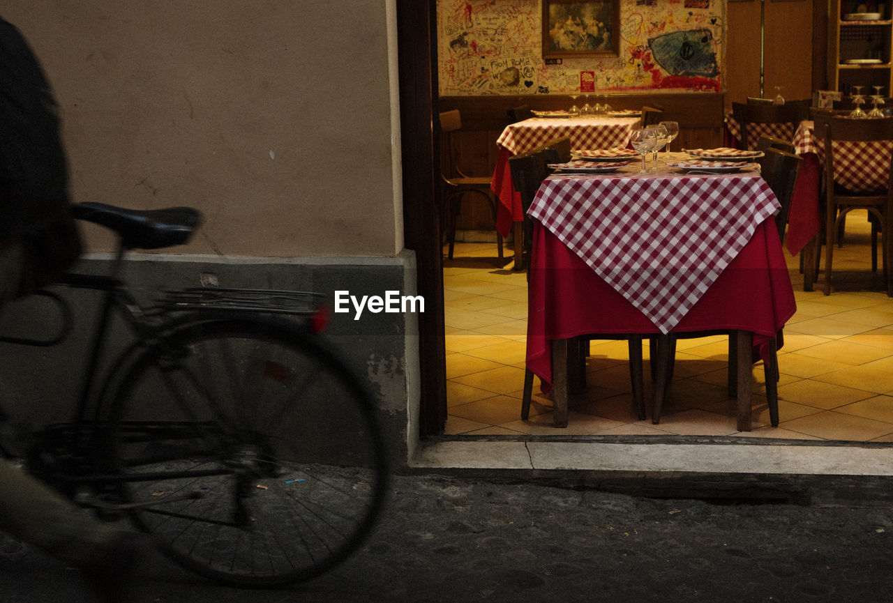 Empty chairs and tables in cafe at night