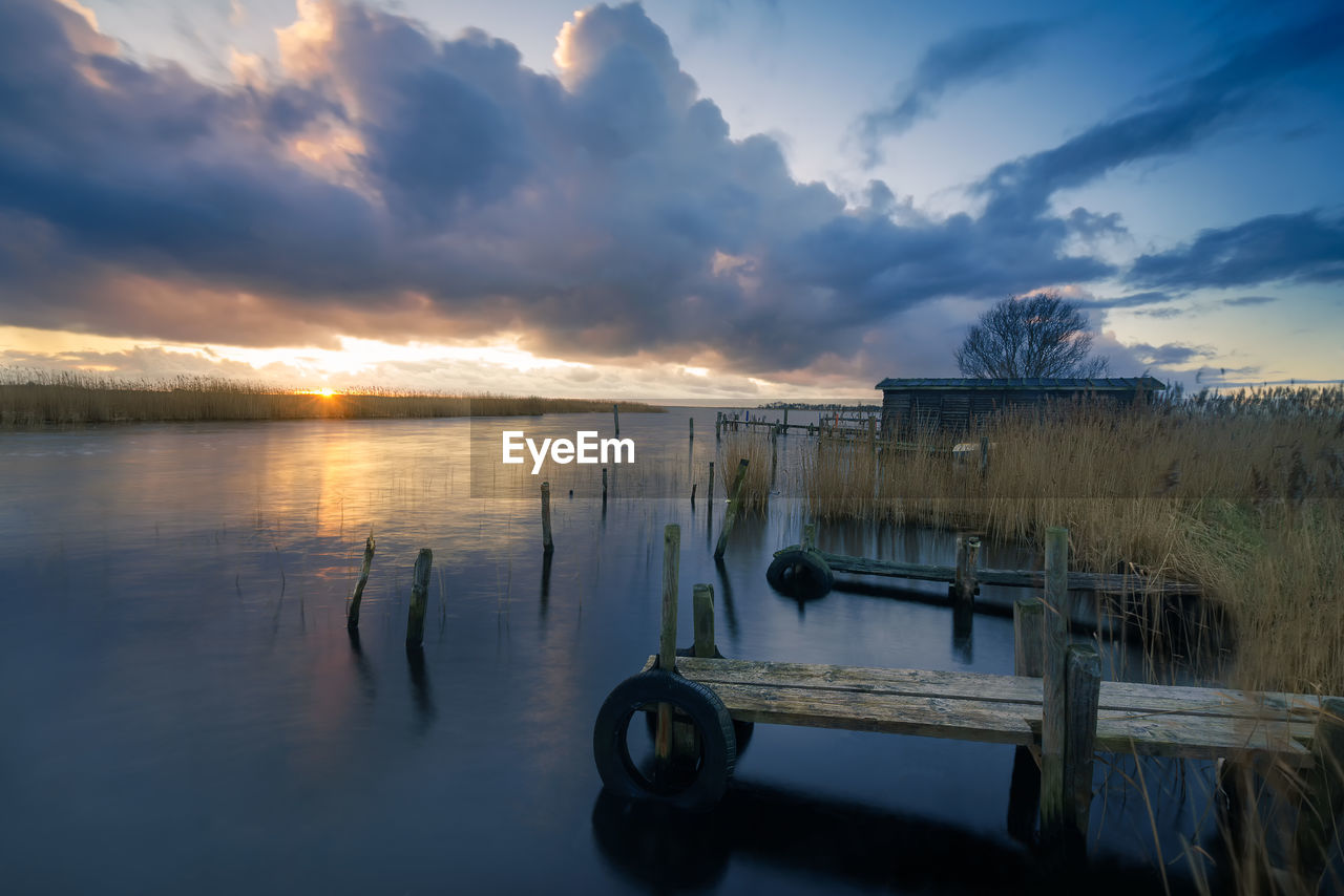 Scenic view of lake against sky during sunset