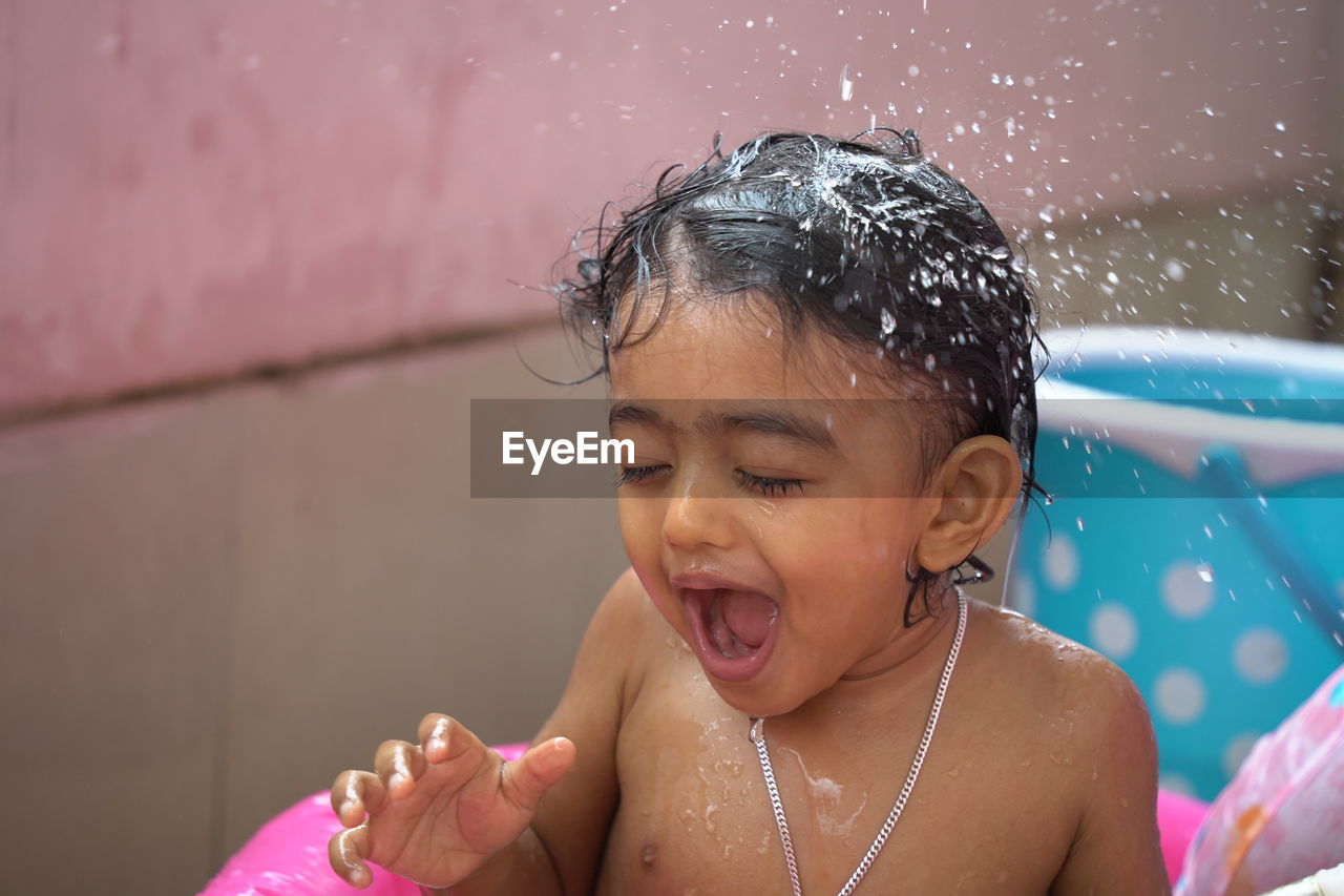 PORTRAIT OF GIRL WITH SWIMMING POOL IN WATER