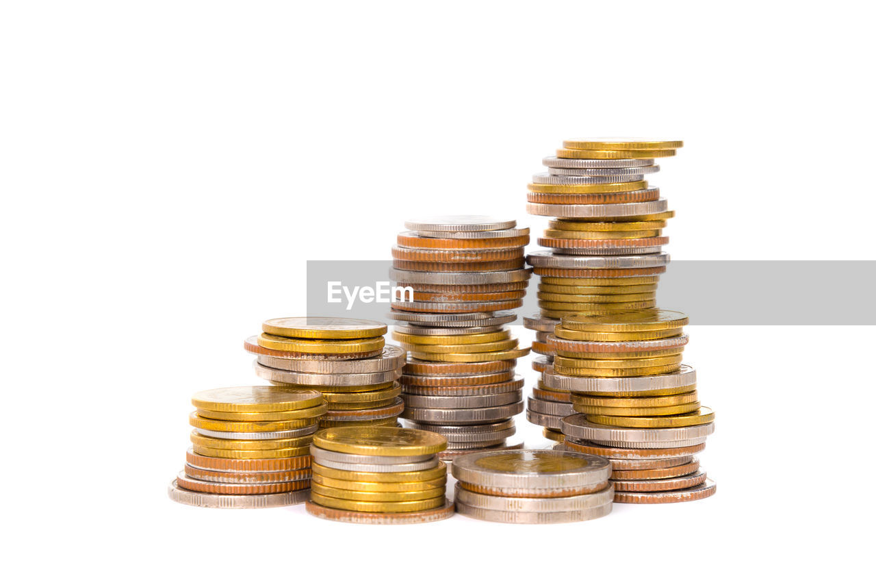 Stacked coins on white background