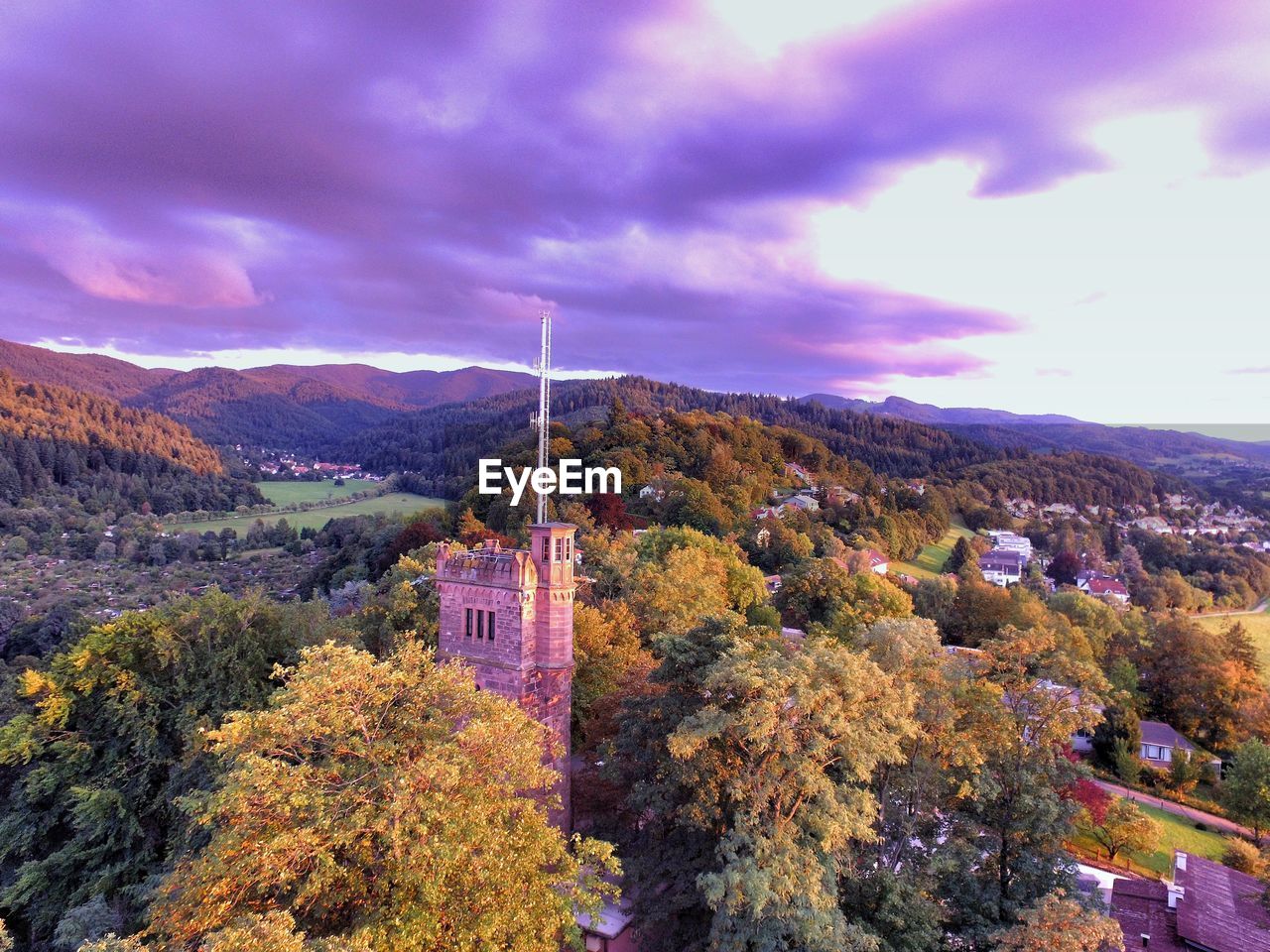 SCENIC VIEW OF TREES AND MOUNTAINS AGAINST SKY