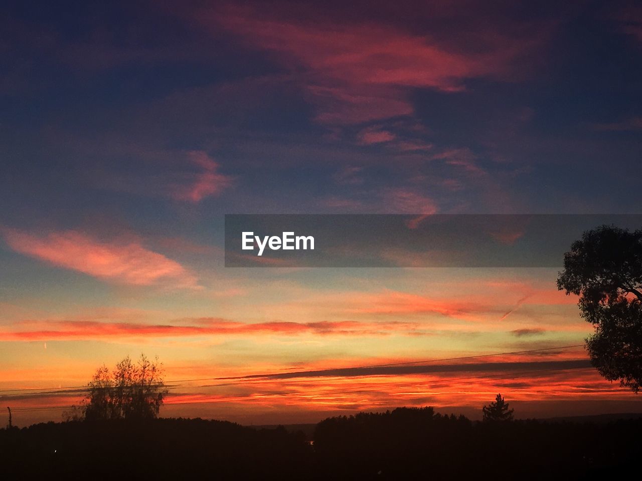 SILHOUETTE OF LANDSCAPE AGAINST SUNSET SKY