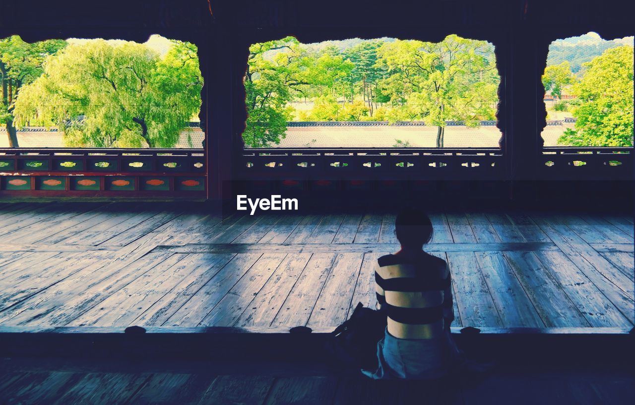 Woman meditating in empty buddhist hall