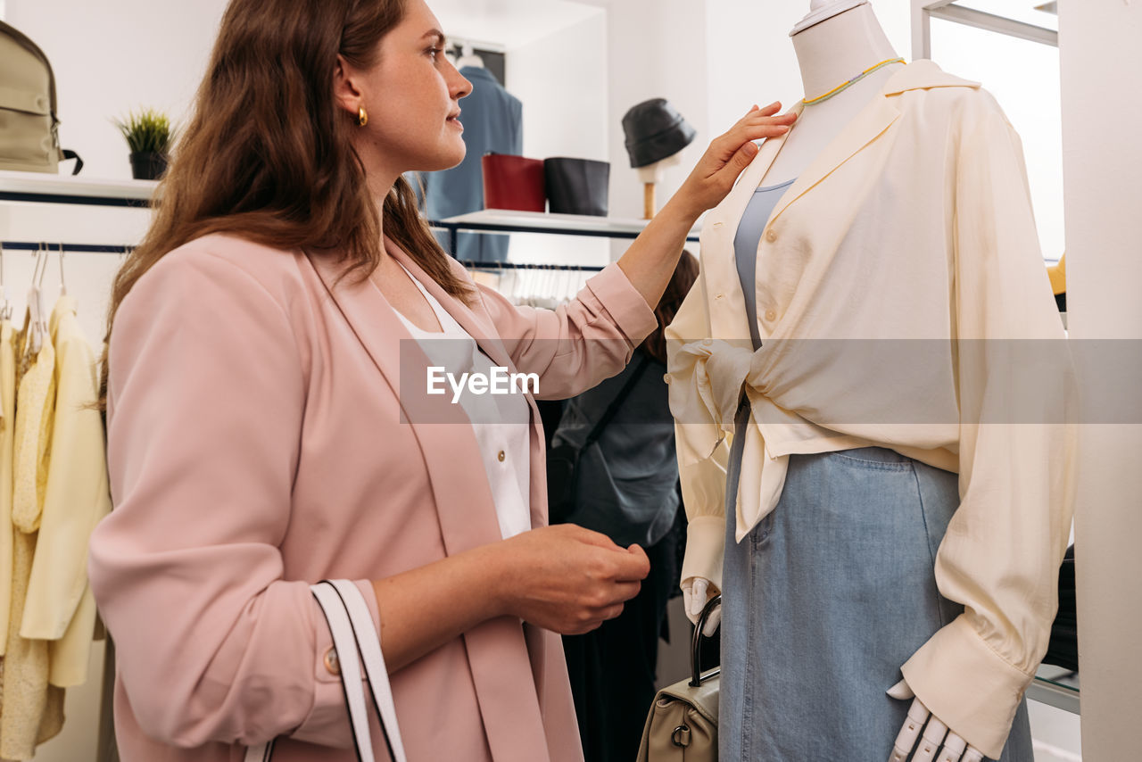 Midsection of woman standing in store