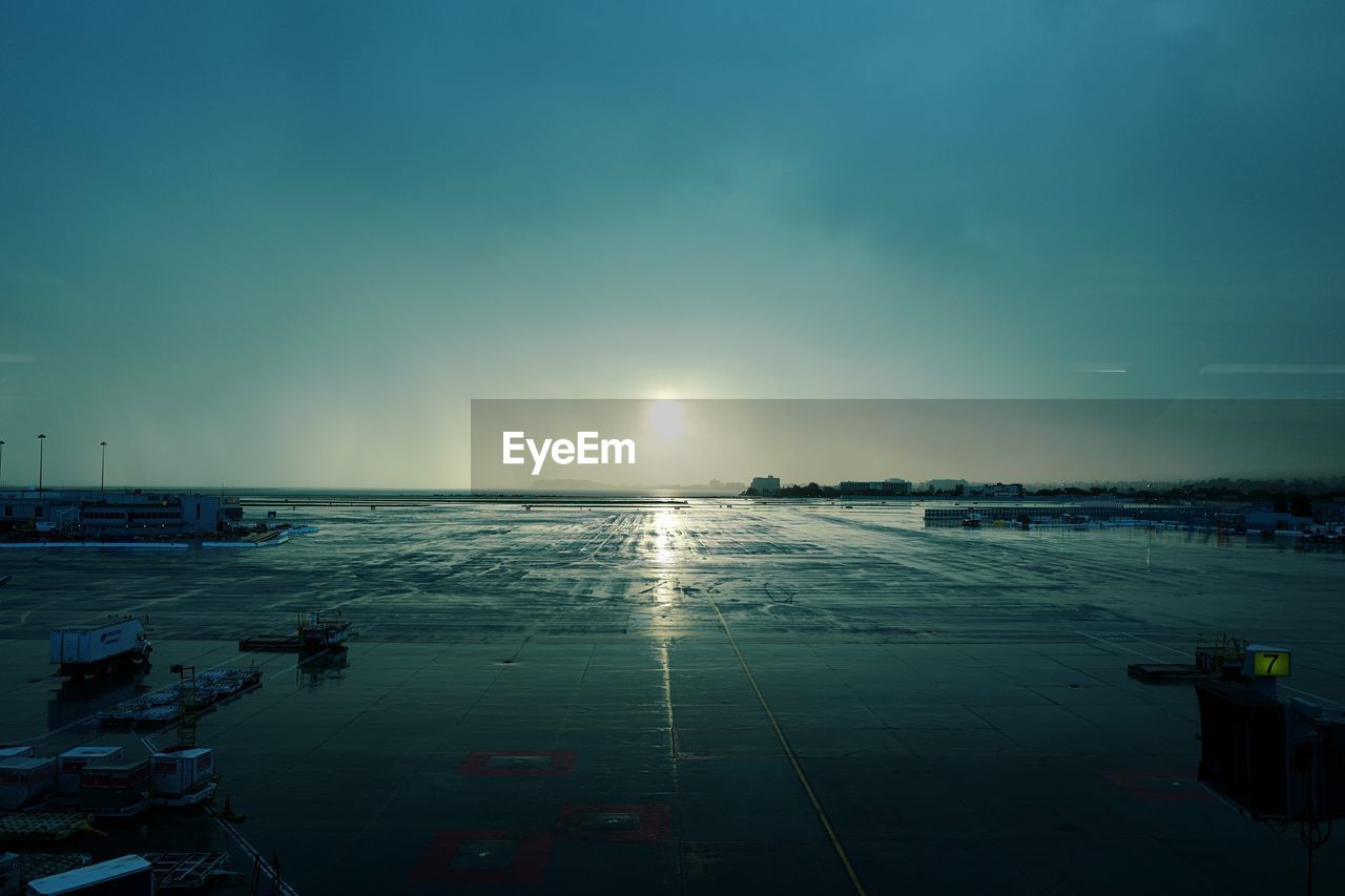 Wet san francisco international airport against blue sky during sunset