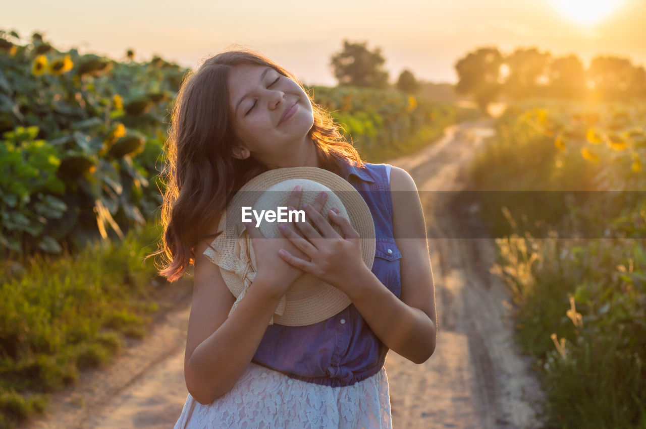 Young woman in sunflower farm