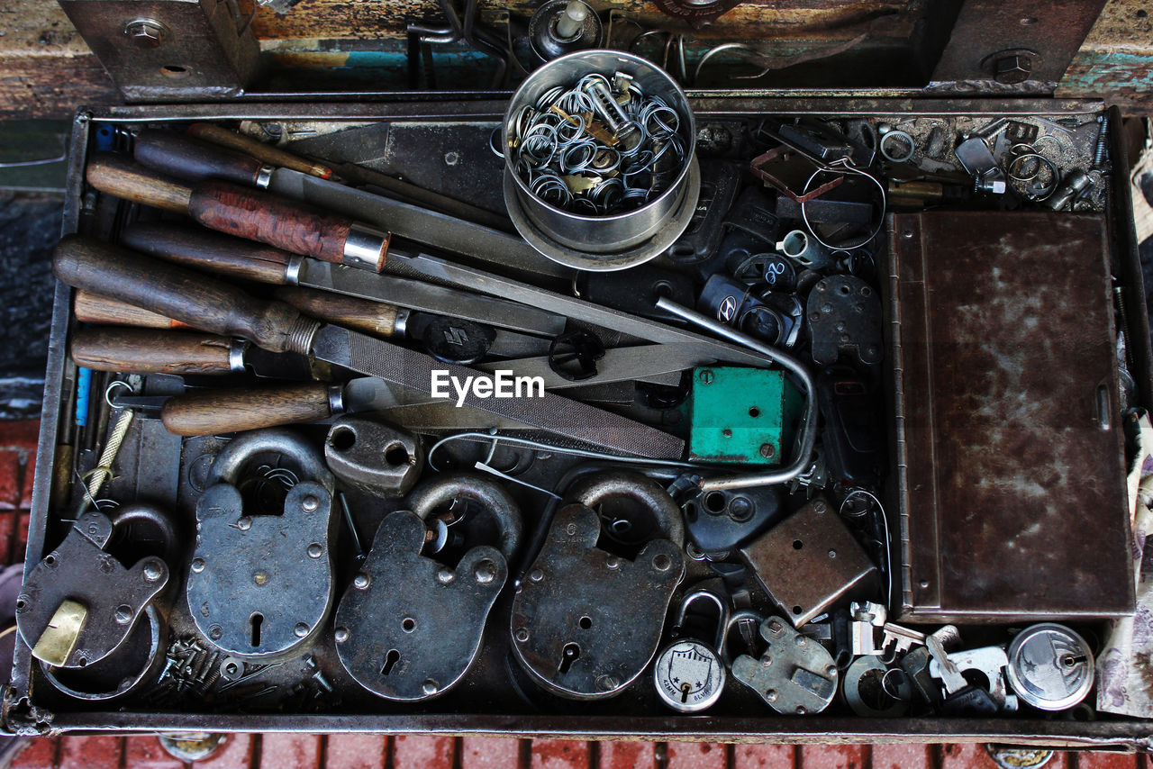 High angle view of work tools with locks and keys on table