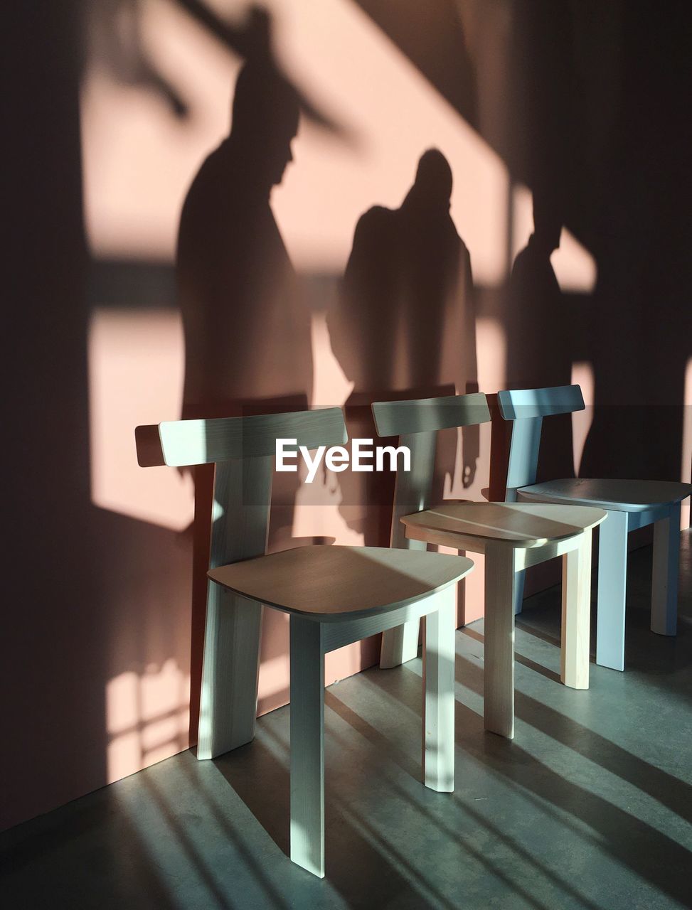 CHAIRS AND TABLE ON ILLUMINATED FLOOR