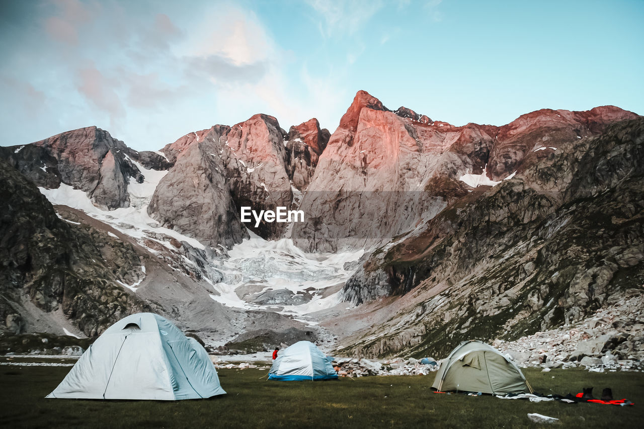 Tent on land against mountains